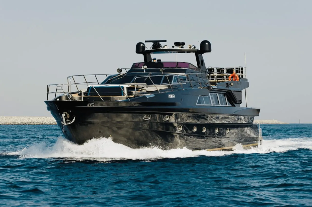 Gulf Craft Black 95 ft yacht cruising off the Dubai coastline