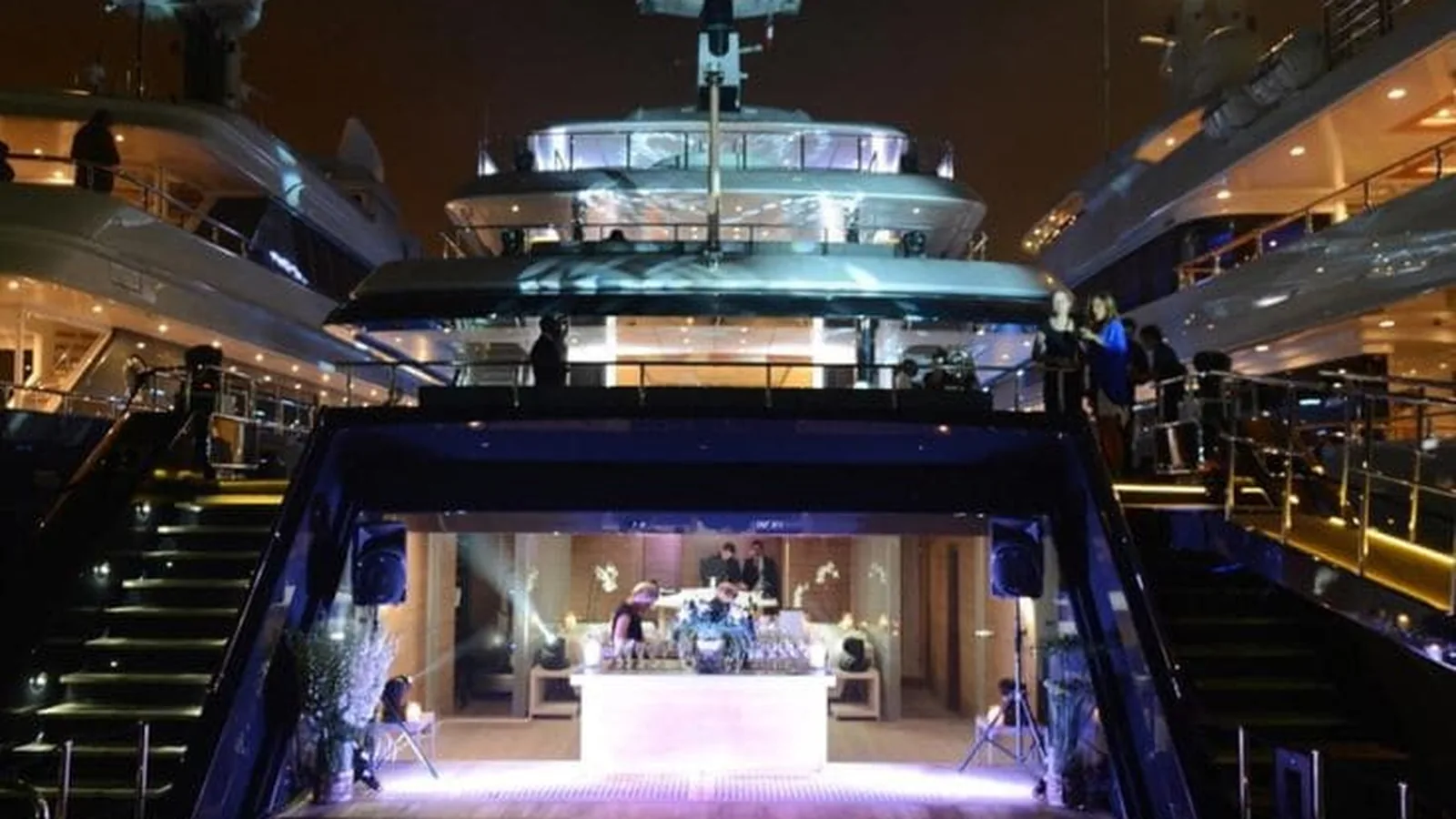 Yacht deck at night with a DJ booth and buffet for a large party in Dubai